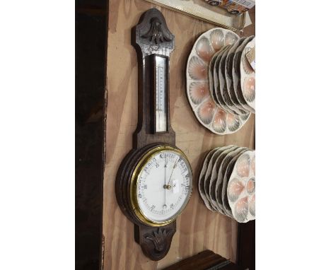 A Victorian carved oak banjo wall barometer. 