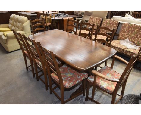 A Mid 20th Century Ercol Medium Elm Refectory Table with 8 Conforming Ladder Back Dining Chairs Inc 2 x Carvers 
