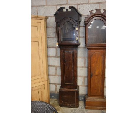 A primitive oak longcase clock case, early 18th CenturyHaving a twin swan neck pediment above a break arched glazed door flan