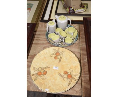 A 1930's Crown Ducal charger in shades of orange along with a Poole mottled grey and green coffee set. 