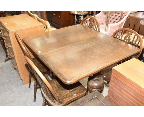 A Mid 20th Century oak refectory table and a set four elm seated ladder back kitchen chairs. 