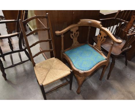 An early 20th Century oak corner chair along with a rush seat ladder back chair. (2) 