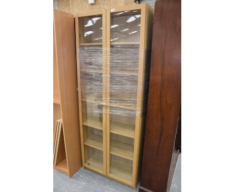 A pair of modern glazed light oak bookcases. 