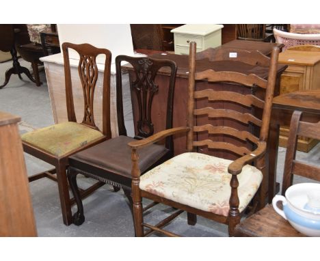 A 19th Century style oak ladder back elbow chair, a Chippendale style mahogany dining chair on ball and claw feet and one oth
