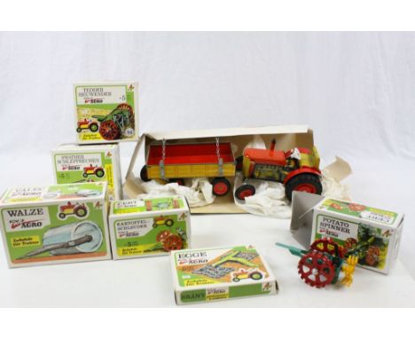 Eight boxed Kovap (Czech) tin plate farming models to include Tractor and Trailer (loose box) and 7 x  Tractor Accessories, a