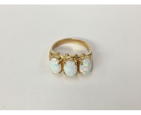 A large 3 stone yellow gold and opal ring, size O