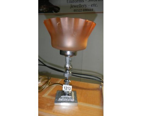 An Art Deco chrome lamp with shade