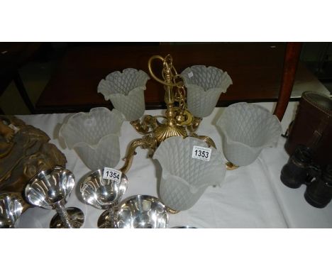 A 5 branch brass ceiling light with shades