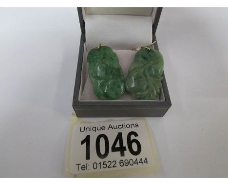 A pair of 9ct gold and jade earrings
