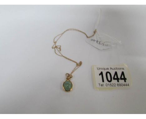 A 9ct gold and jade pendant