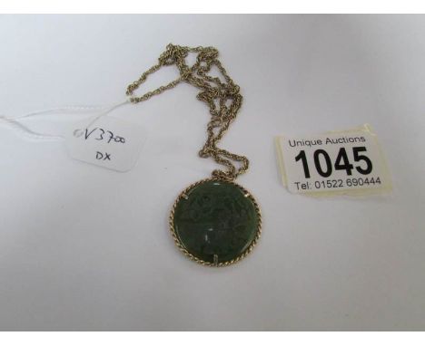 A 9ct gold and jade pendant on gold chain