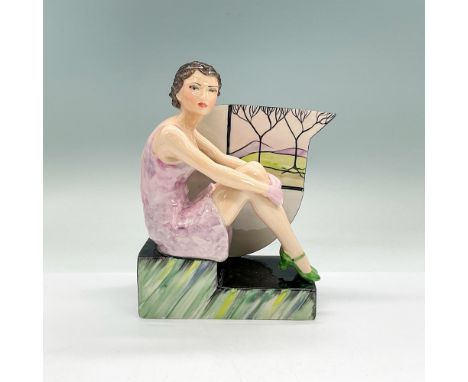 Hand painted glazed ceramic Art Deco prototype figure of a lady in a light violet dress sitting on a step with an accent wall