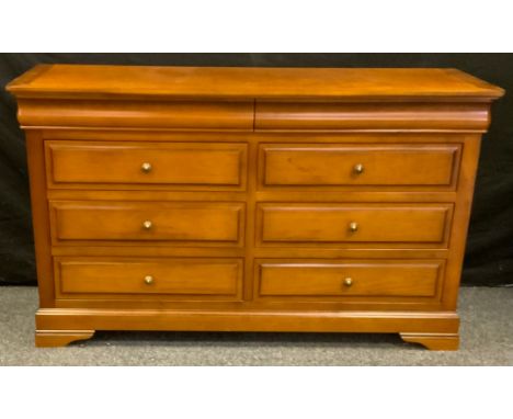 A contemporary sideboard, rounded rectangular top above an arrangement of drawers, bracket feet, 82cm high, 142cm wide, 50cm 
