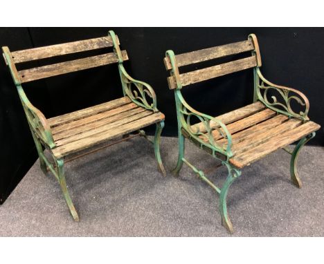 A pair of early 20th century cast iron bench end garden chairs (2) 