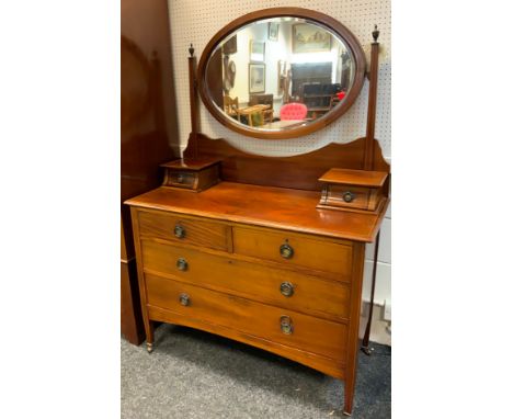 An Edwardian mahogany inlaid wardrobe, outswept cornice above a central bevelled mirrored door and a long deep drawer, outlin