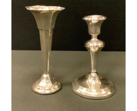 A George V silver candlestick, weighted base, Birmingham 1916;  a bud vase, weighted base, Sheffield 1918, 224g gross (2) 