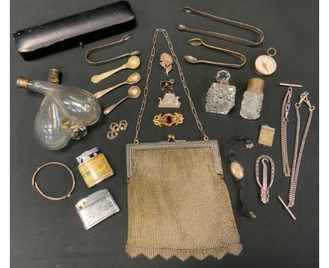 A silver topped smelling salt bottle;  a silver collar and clear glass scent bottle;  a pair of George III silver sugar bows;