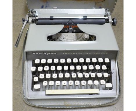 A Remington typewriter with carbon copy paper and accessories, reels, etc., cased