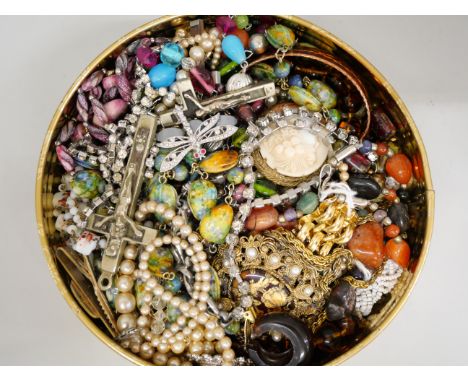 A tin of vintage costume jewellery 
