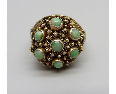 A Chinese export silver gilt filigree and cabochon jade ring, U/V (adjustable)