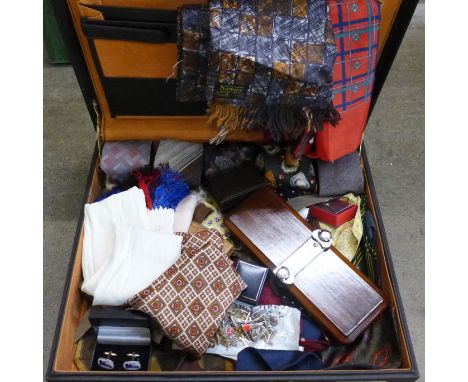 Twelve gentleman's cravats including silk, four scarves, tie presses, cufflinks, tie-pins, etc., in a leather briefcase