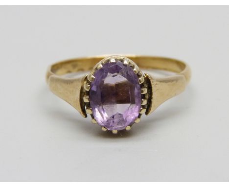 A yellow metal and amethyst ring marked 22ct, adapted from a wedding band, in a vintage box, 2.5g, O