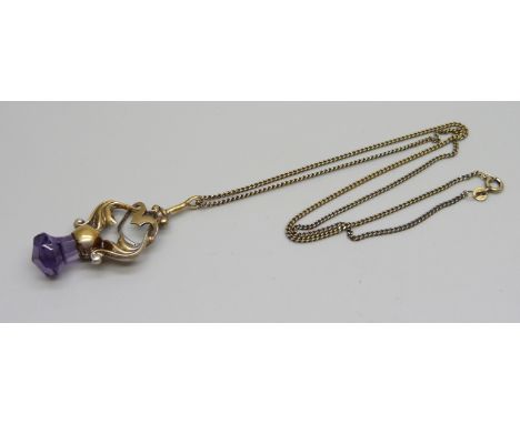A gilt Art Nouveau pendant on a silver gilt chain 