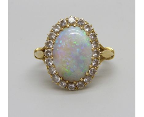 An 18ct gold opal and diamond cluster ring, H.B &amp; Co, opal 1.3cm x 0.9cm, shallow chip to opal, 5.1g, O/P