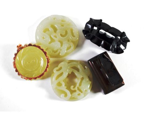 A Chinese Jade Disk, carved with a chimera, 5cm diameter; A Similar Disk, 6cm diameter; and A Similar Disk, as a chrysanthemu