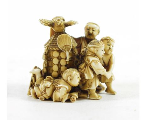 A Japanese Ivory Okimono, Meiji period, as four children and a dog  playing around a hut, a bird perched on the roof, 5cm hig