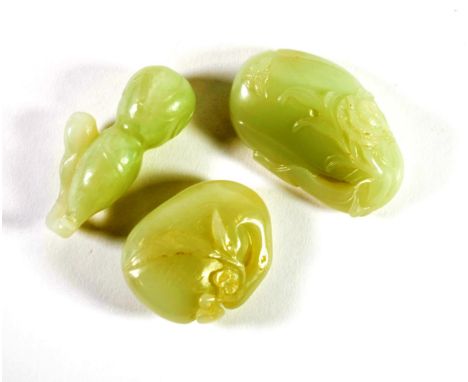 A Chinese Jade Carving of a Gourd, 6cm long; A Similar Carving of a Fruit, 5cm long; and A Similar Carving of a Fruit, 6cm lo