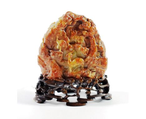 A Chinese Russet Jade Boulder, carved with a figure and a deer amongst trees, 8cm high