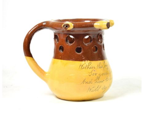 An Isaac Button Soil Hill Pottery Slipware Puzzle Jug, 20th century, inscribed WITHIN THIS JUG THERE IS GOOD LIQUOR …, incise