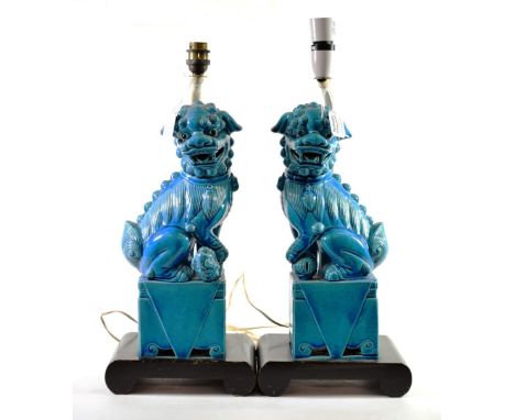 A Pair of Chinese Turquoise Glazed Porcelain Dogs of Fo, in Kangxi style, of traditional form on rectangular bases, 36cm high