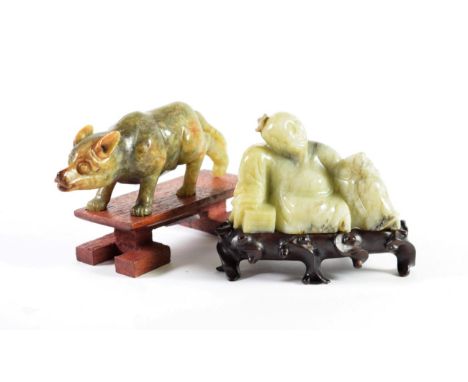 A Chinese Jade Type Figure of a Seated Man, a pot at his back, 8.5cm wide; and A Similar Figure of a Crouching Wolf, 15cm wid