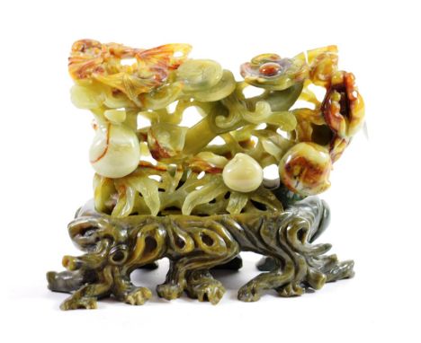 A Chinese Jade Type Floral Carving, of rectangular form decorated with flowering branches, 24cm wide, on a soapstone base