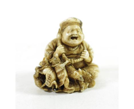 A Japanese Ivory Netsuke, Meiji period, in the form of Daikoku and five rats, signed to red lacquer tablet, 4.5cm high 