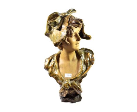 A Goldscheider Style Part Glazed Terracotta Bust of a Art Nouveau Maiden, circa 1910, wearing a loose cap and cloak picked ou