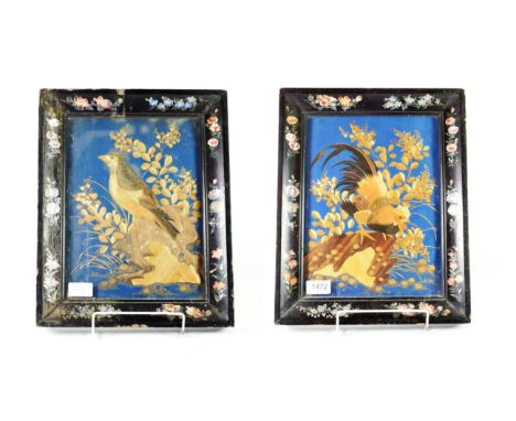 A Pair of Japanese Straw-Work Pictures, 19th century, depicting birds amongst foliage and rockwork on a blue ground, within e