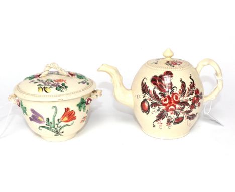 A Creamware Teapot and Cover, circa 1770, painted in the manner of Robinson &amp; Rhodes with red and black flowersprays, 14.
