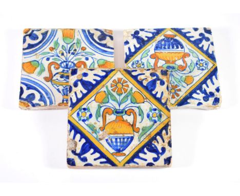 A Pair of Delft Tiles, mid 17th century, in colours with vases of flowers within blue spandrels, 14cm wide; and A Similar Til