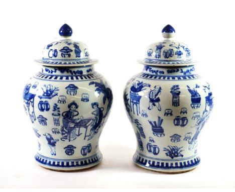 A Pair of Chinese Porcelain Baluster Jars and Covers, Kangxi reign marks but not of the period, painted in underglaze blue wi