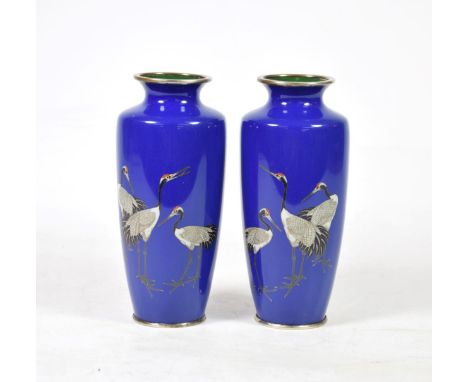A Pair of Japanese Cloisonné Enamel Vases, Meiji period, of baluster form, decorated with cranes on a blue ground, 18cm high