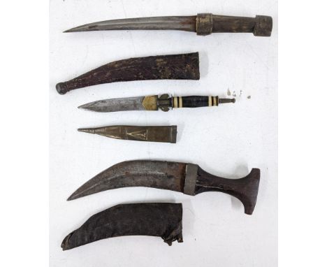 Three daggers to include an early 20th century Mandau style Indonesian Borneo tribal dagger, a West African Mauritania Arab B