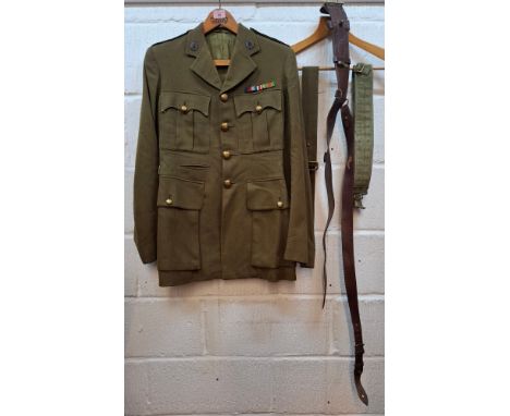 A mid 20th Century British Army jacket having officer's service dress collar badges and 3 military belts. Location:RailIf the