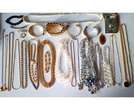 A quantity of vintage costume jewellery to include an engraved yellow metal hinged bangle, a Native American silver phoenix p