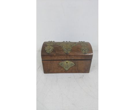 An 19th century walnut domed topped tea caddy with brass decoration to the lidLocation:If there is no condition report, pleas