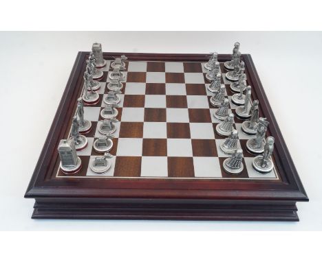 A Danbury Mint BBC licenced Doctor Who chess set, with 38 pewter chess pieces in original wooden box with chess board top, wi