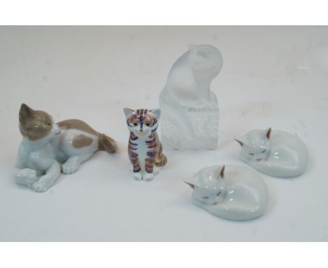 A group of ceramic and glass cats, to include a modern Lalique frosted glass cat sat atop a rectangular base with vine motifs