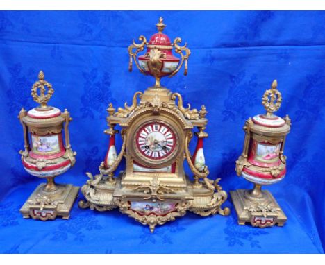 A FRENCH GILT SPELTER AND PORCELAIN CLOCK GARNITURE with countwheel strike, the clock case 47cm high, flanked by urns, decora